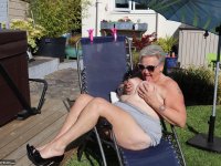 Fat nan Valgasmic Exposed licks a shoe while exposing herself in the backyard - Photo #1