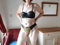 Old woman Kat Kitty masturbates with a sex toy on top of her bed - Photo #1