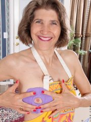 Horny older granny naked in her apron toying with rolling pin in the kitchen