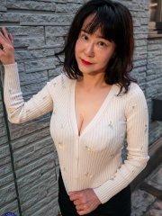 Japanese lady Ayane frees her big tits before standing naked in a kitchen