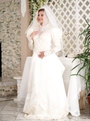 Carolina Sweets is affixed with a garter before a lesbian wedding to Julia Ann