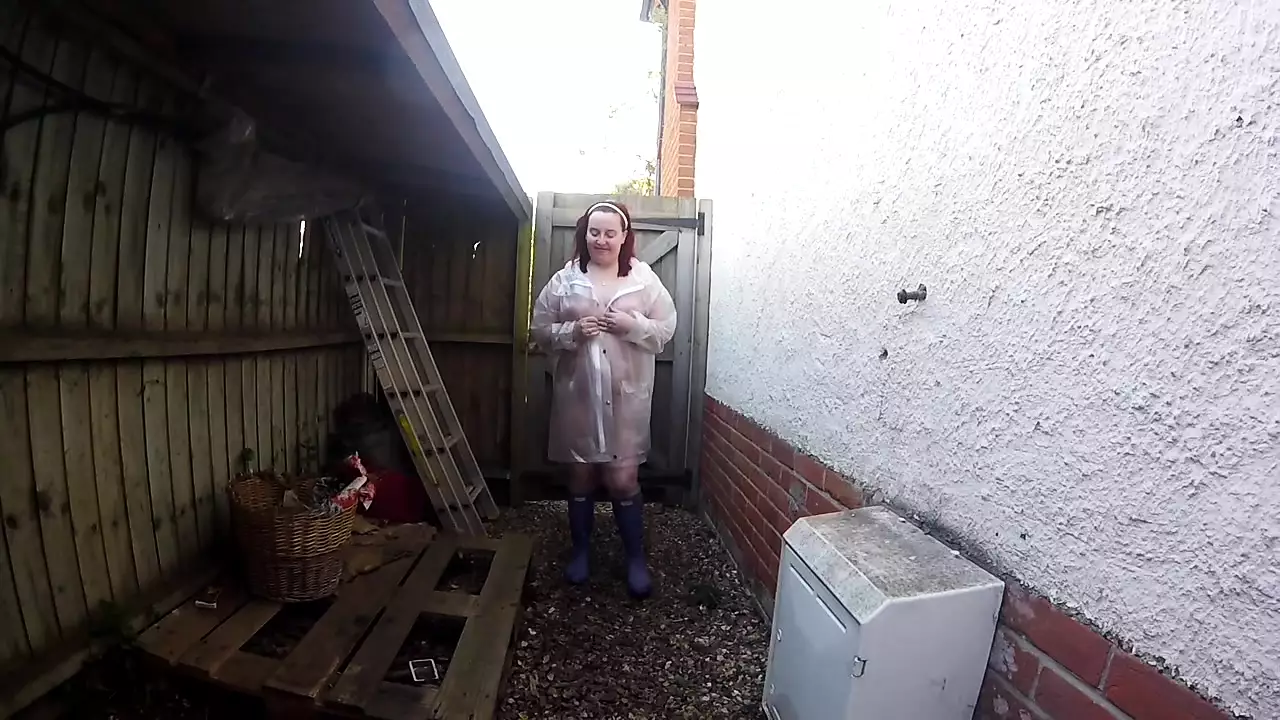 sexy wife Haley outdoors in plastic mac and Wellingtons