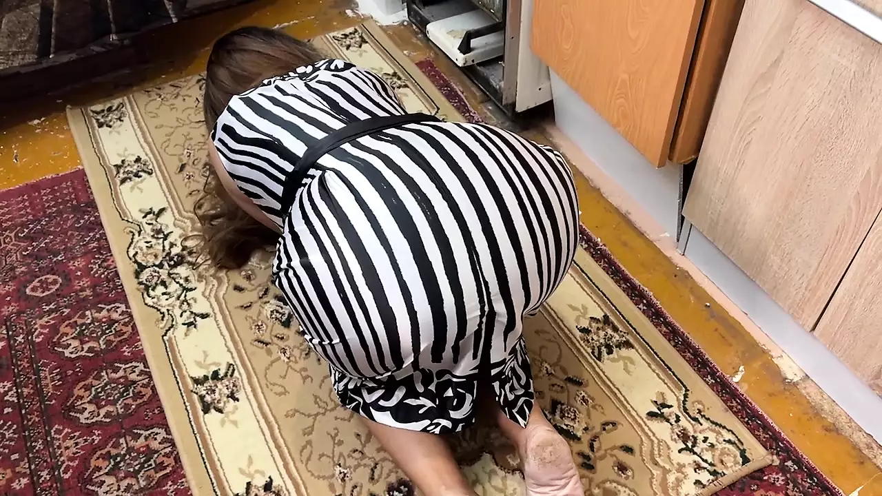 On the floor, a housewife is on her knees and feels a dick in her ass when she has anal sex