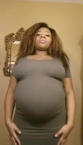 Pregnant ebony belly rub