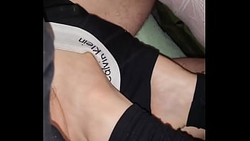 Stepmom teasing Stepson with her feet under his boxershorts